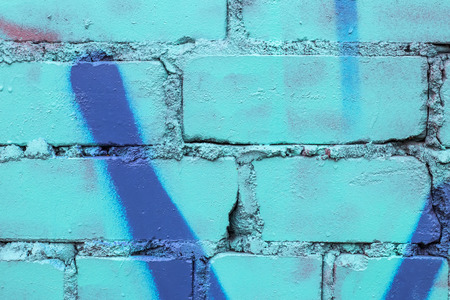 Fragment of colored graffiti painted on a brick wall. Texture. Abstract background for design.の写真素材