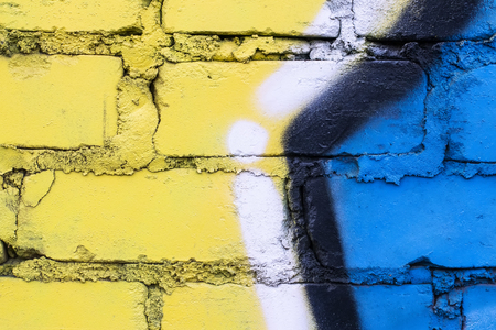 Fragment of colored graffiti painted on a brick wall. Texture. Abstract background for design.の写真素材