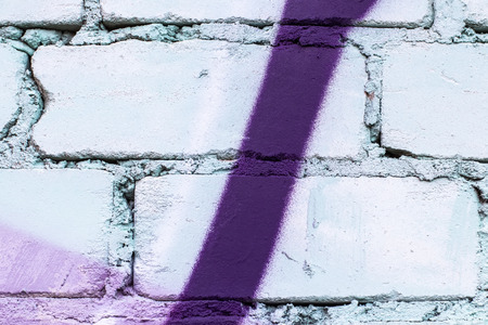 Fragment of colored graffiti painted on a brick wall. Texture. Abstract background for design.の写真素材