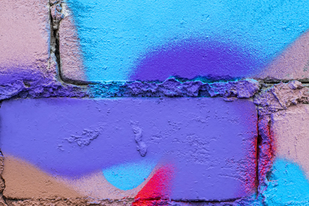 Fragment of colored graffiti painted on a brick wall. Texture. Abstract background for design.の写真素材