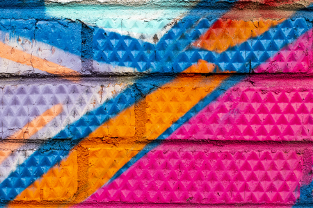 Fragment of colored graffiti painted on a brick wall. Texture. Abstract background for design.の写真素材