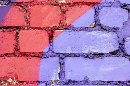 Fragment of colored graffiti painted on a brick wall. Texture. Abstract background for design.