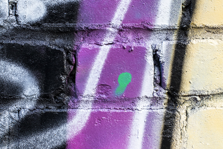 Fragment of colored graffiti painted on a brick wall. Texture. Abstract background for design.の写真素材