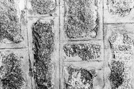 Black and white background of ancient stone wall. Texture of old brick. Monochrome.の写真素材