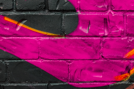Fragment of colored graffiti painted on a brick wall. Texture. Abstract background for design.の写真素材