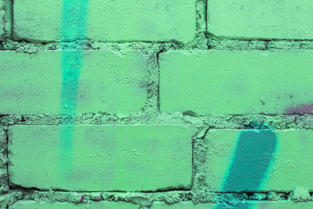 Fragment of colored graffiti painted on a brick wall. Texture. Abstract background for design.の写真素材