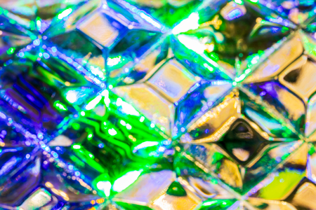 Lights of garland, reflected in the crystal. Glowing texture. Abstract background for design.