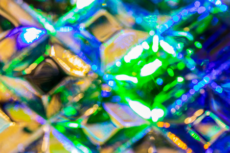 Lights of garland, reflected in the crystal. Glowing texture. Abstract background for design.の写真素材