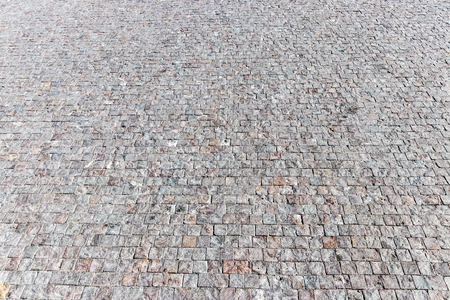 Top view on paving stone road. Old pavement of granite texture. Street cobblestone sidewalk. Abstract background for design.の写真素材