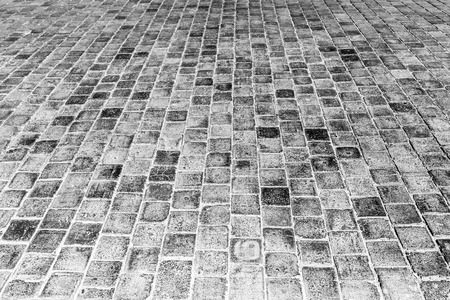 Top view on paving stone road. Old pavement of granite texture. Street cobblestone sidewalk. Abstract background for design.の写真素材