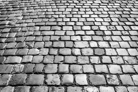 Top view on paving stone road. Old pavement of granite texture. Street cobblestone sidewalk. Abstract background for design.の写真素材