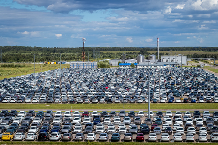 Volkswagen, Russia, Kaluga  - JULY 4, 2019: New cars parked in a distribution center on a sunny day in the summer, a car factory. Parking in the open air.のeditorial素材
