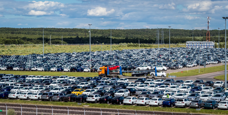 Volkswagen, Russia, Kaluga  - JULY 4, 2019: New cars parked in a distribution center on a sunny day in the summer, a car factory. Parking in the open air. Panorama.のeditorial素材