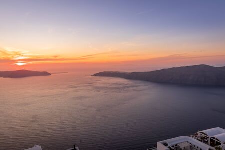 Sunset overlooking the caldera and the sea in the village of Imerovigli on the island of Santorini in the summer. Greece.の写真素材