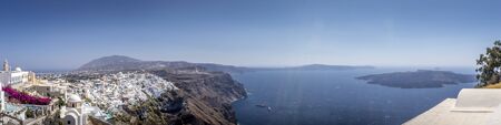 Thira city on Santorini island on a clear sunny day. Cliff overlooking the sea and the caldera. Greece.の写真素材