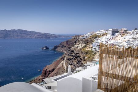 Oia city on Santorini island on a clear sunny day. Cliff overlooking the sea and the caldera.の写真素材