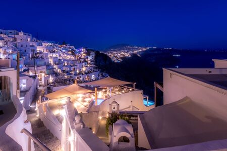 The capital of the island of Santorini Thira at night. Hotel lights and illumination. Cliff overlooking the caldera.の写真素材
