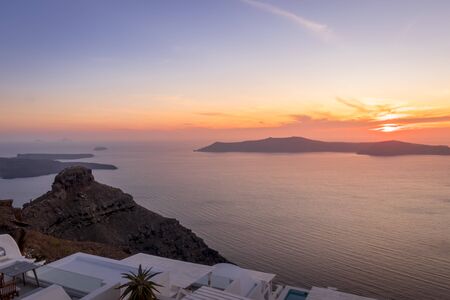 Sunset overlooking the caldera and the sea in the village of Imerovigli on the island of Santorini in the summer. Greece.の写真素材