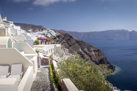 Oia city on Santorini island on a clear sunny day. Cliff overlooking the sea and the caldera.の写真素材