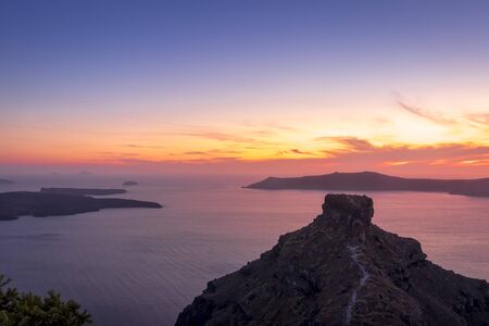 Scene of sunset overlooking the caldera and the sea in the village of Imerovigli on the island of...