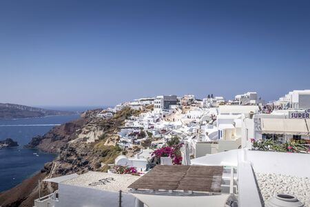 Oia city on Santorini island on a clear sunny day. Cliff overlooking the sea and the caldera.の写真素材