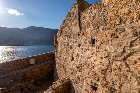 Old buildings and ruins of Spinalonga on a sunny day. Crete, Greece, Aegean sea.の写真素材