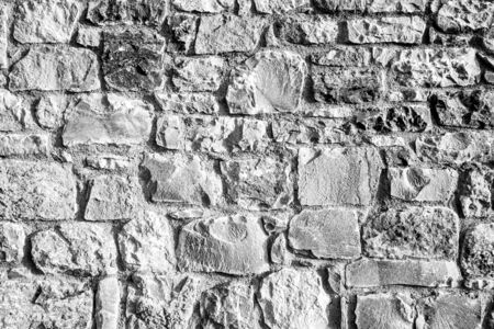 Background of ancient stone wall. Texture of old brick.の写真素材