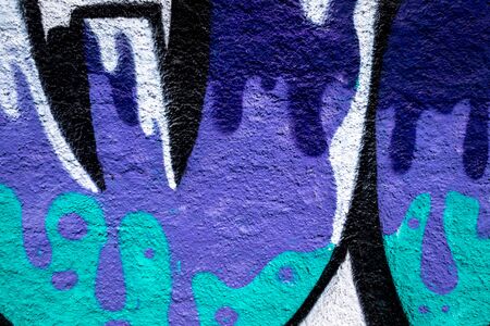 Fragment of colored graffiti painted on a concrete wall. Texture. Abstract background for design. Peeling color paint.の写真素材