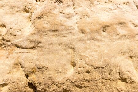 Texture of a yellow stone rock. Abstract background for design.