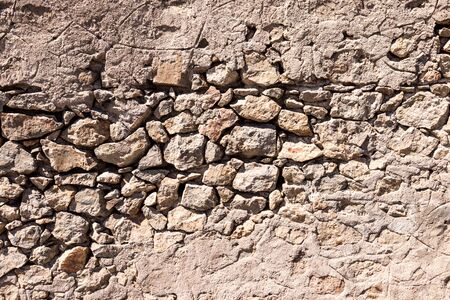 Background of ancient stone wall. Texture of old brick.の写真素材