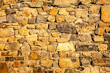Background of ancient stone wall. Texture of old brick.の写真素材