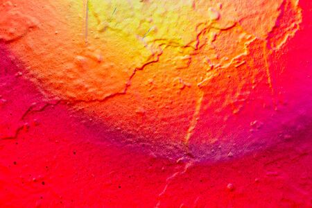 Fragment of colored graffiti painted on a concrete wall. Abstract background for design. Bright paints.の写真素材