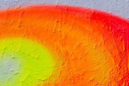 Fragment of bright graffiti painted on a stone wall.