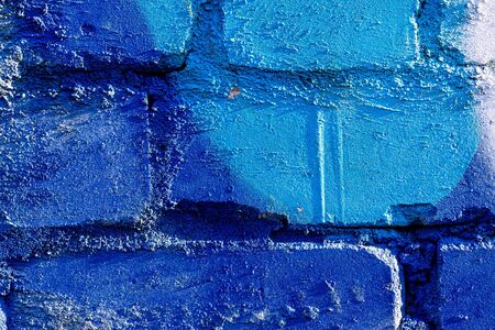 Fragment of colored graffiti painted on a brick wall. Bright abstract background for design.の写真素材