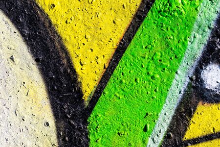 Fragment of colored graffiti painted on a concrete wall. Bright abstract background for design.の写真素材