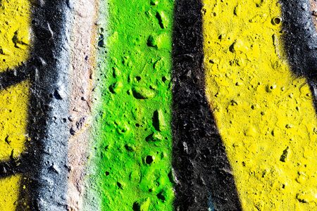 Fragment of colored graffiti painted on a concrete wall. Bright abstract background for design.