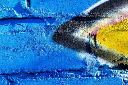 Fragment of colored graffiti painted on a brick wall. Bright abstract background for design.の写真素材
