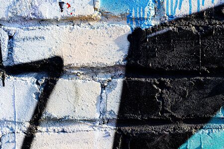 Fragment of colored graffiti painted on a brick wall. Bright abstract backdrop for design.