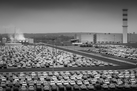 Volkswagen, Russia, Kaluga  - NOVEMBER 21, 2019: New cars parked in a distribution center on a cloudy rainy day in the autumn, a car factory. Parking in the open air. Black and white photo.のeditorial素材