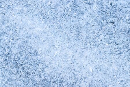 Texture of ice in the winter. Abstract background for design, photographed closeup. A melting or...