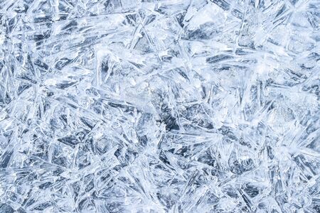 Texture of ice in the winter. Abstract background for design, photographed closeup. A melting or...