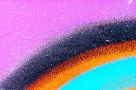 Fragment of colored graffiti painted on a wall. Bright abstract background for design.