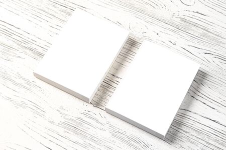 Two white books on a wooden table. Abstract background for design. Art stylized baner or mock up with copy space for a text.の写真素材