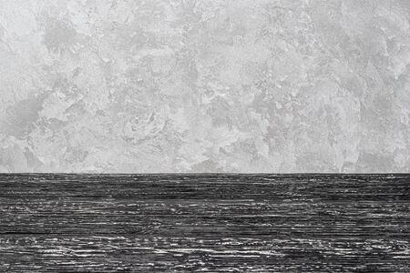 Black wooden floor over concrete or decorative plaster wall background. Blank for design.の写真素材