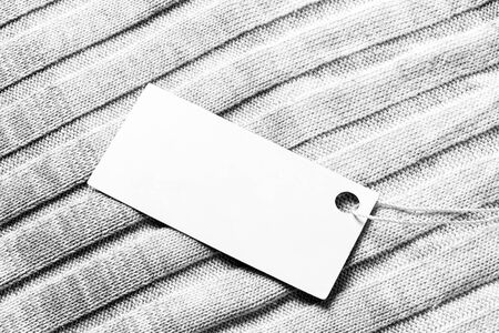 White label on a woolen fabric. Abstract background for design. Art stylized baner or mock up with copy space for a text.の写真素材