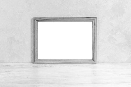 White wooden floor over concrete or decorative plaster wall and photo frame with copy space for a text background. Mock up for design. Monochrome.の写真素材