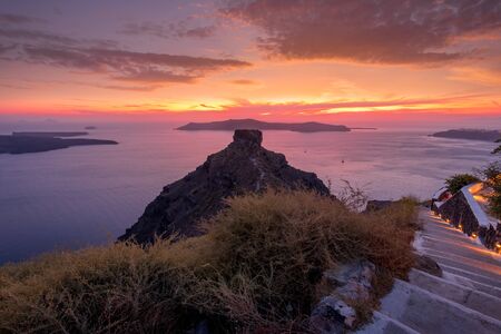 Scene of sunset overlooking the caldera and the sea in the village of Imerovigli on the island of Santorini in the summer. Greece.の写真素材