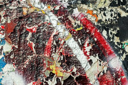 Fragment of colored graffiti painted on a wall. Bright abstract background for design with peeling...