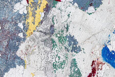 Fragment of colored graffiti painted on a wall. Bright abstract background for design with peeling paint.の写真素材