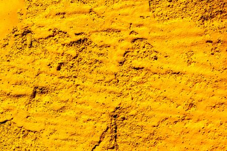 Fragment of colorful graffiti painted on a concrete wall. Bright yellow abstract background for design.の写真素材